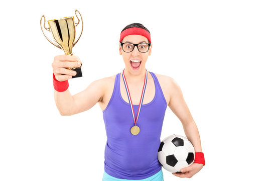 Nerdy football player holding a gold cup