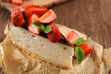 Delicious cheesecake with berries on table close up