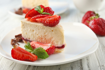 Delicious cheesecake with berries on table close up
