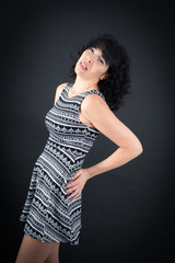 Fototapeta premium Beautiful woman doing different expressions in different sets of clothes: backache
