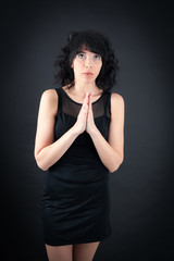 Beautiful woman doing different expressions in different sets of clothes: prayer