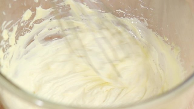 Vanilla seeds being stirred into butter