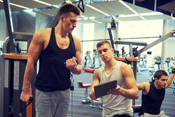 men exercising on gym machine