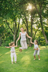 Obraz premium family jumping together at outdoor park