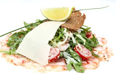 salad greens and shrimp meat on a white background