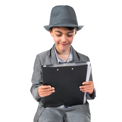 Cute boy sitting on books