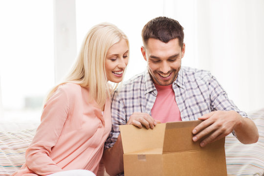 happy couple with parcel box at home