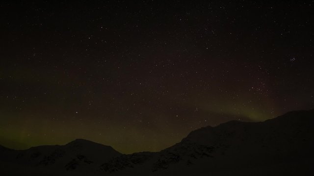 Winter in Arctic. Starry sky in the polar night. Northern Lights over Spitsbergen.