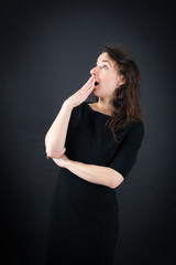 Fototapeta premium Beautiful woman doing different expressions in different sets of clothes: yawn