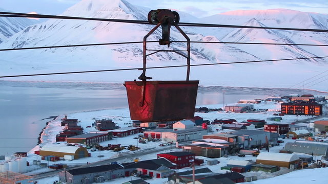  Old abandoned coal cableway over the town of Longyearbyen among snow-capped mountains of the Norwegian archipelago of Svalbard.