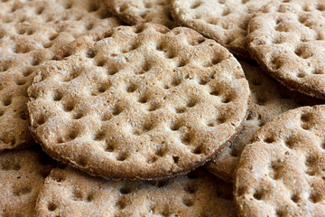 Heap of round rye crispbreads as a background.