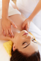 Fototapeta na wymiar Spa Massage. Beautiful Woman Gets Spa Treatment in Salon.