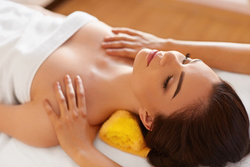 Spa Massage. Beautiful Woman Gets Spa Treatment in Salon.