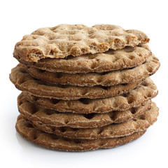Stack of round rye crispbreads isolated on white. One broken in