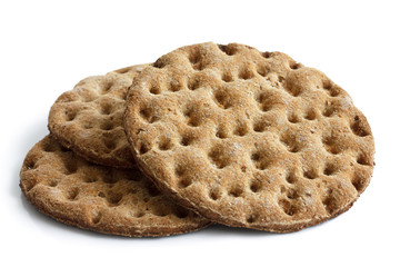 Stack of three round rye crispbreads isolated on white.