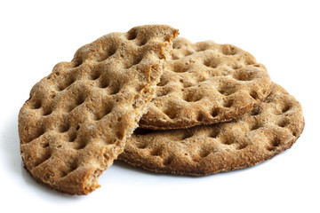 Stack of three round rye crispbreads isolated on white. One brok