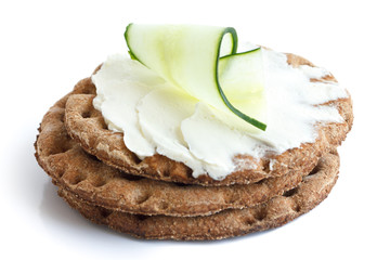 Stack of round rye crispbreads isolated on white. Top one spread