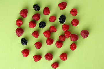 raspberries and blackberries light green background