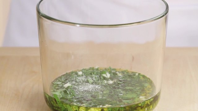 Garlic and herb marinade being seasoned