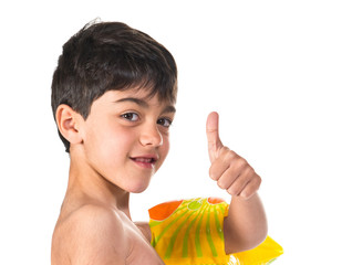 Boy in swimsuit making ok gesture