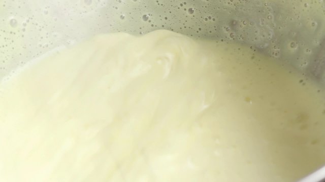 Beating cr&egrave;me in bowl over pan of simmering water