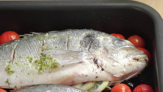 Brushing seabream with herb oil