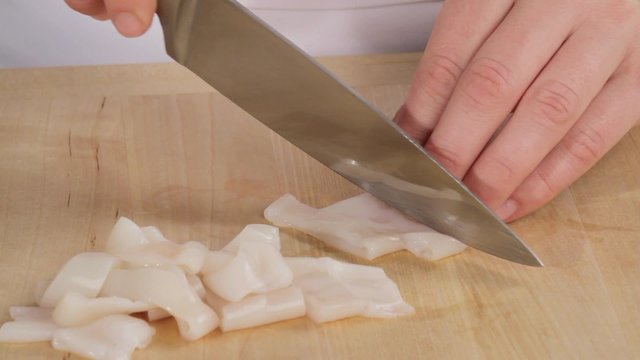 Squid tubes being cut into rings
