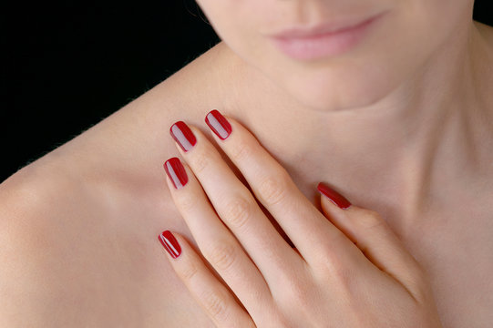Young beauty with polished red finger nails
