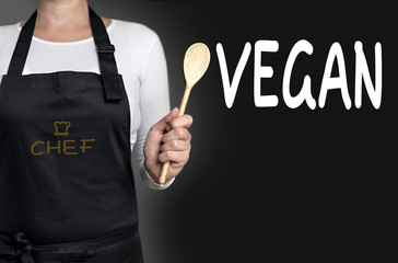 vegan chef holding wooden spoon background