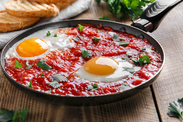 fried eggs in tomato sauce in the pan