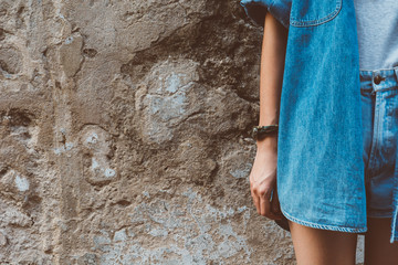 watch bracelet on hand and jean with film texture in vintagestyl
