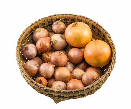 onions and shallots in old basket isolated on white background