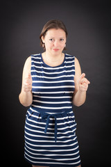 Beautiful woman doing different expressions in different sets of clothes: gun sign