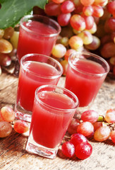 Grape juice pink grapes with fresh berries, selective focus