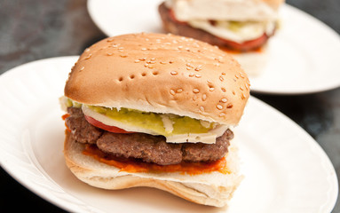 Real homemade hamburgers with cheese and avocado. No fake food styling, this is real food.