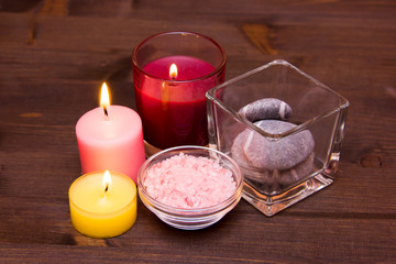 Candles and bath salts on wooden table