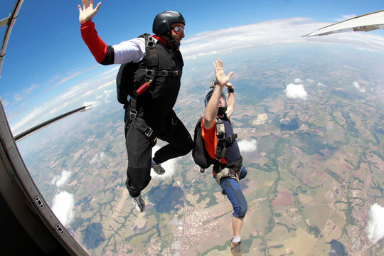 Skydiving friends jumping from the plane