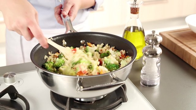 Vegetable couscous being seasoned
