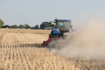 Fototapeta premium Farmer in tractor preparing land for sowing 
