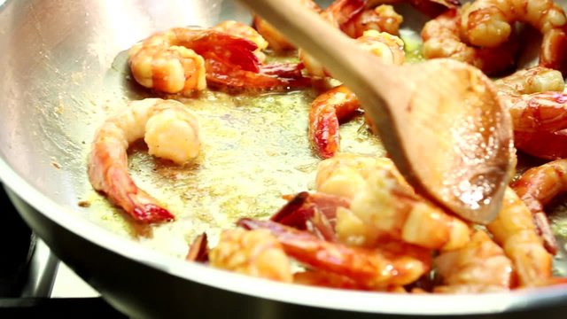Prawns being fried in a pan