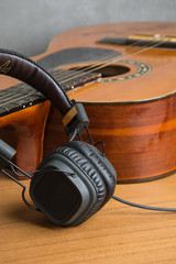 headphone and guitar on wood