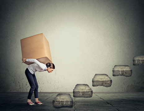 Difficult Task Concept. Young Woman Carrying Heavy Box Upstairs