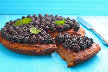 homemade chocolate cake with nuts and blackberry