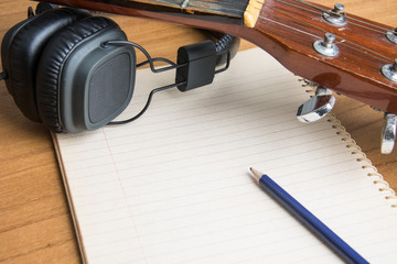 headphone guitar notebook and pencil