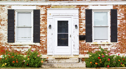 Fototapeta na wymiar Antique Front Door Windows and Flower Bed