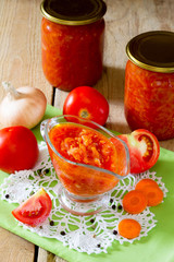 Tomato-onion sauce on homemade wooden background