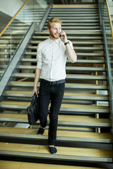 Fototapeta premium Young businessman on the stairs
