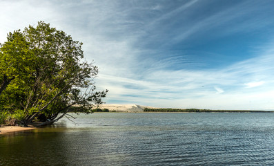 View from the beach to the bay with sandy dune on the background
