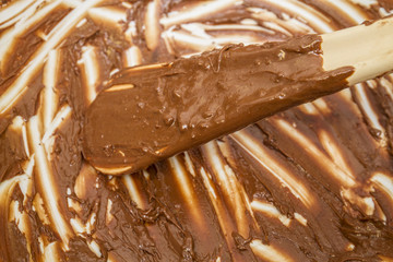 scraping last of the melted chocolate from bowl