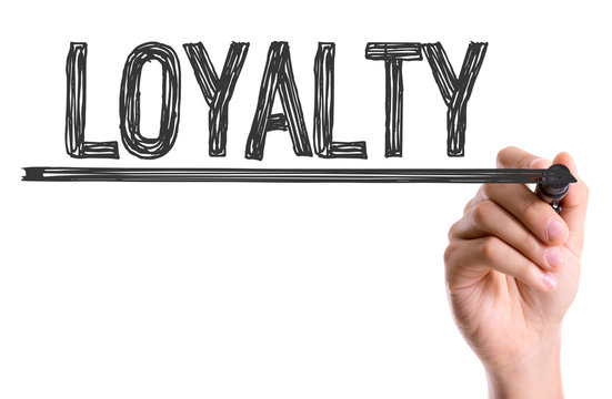 Hand with marker writing the word Loyalty